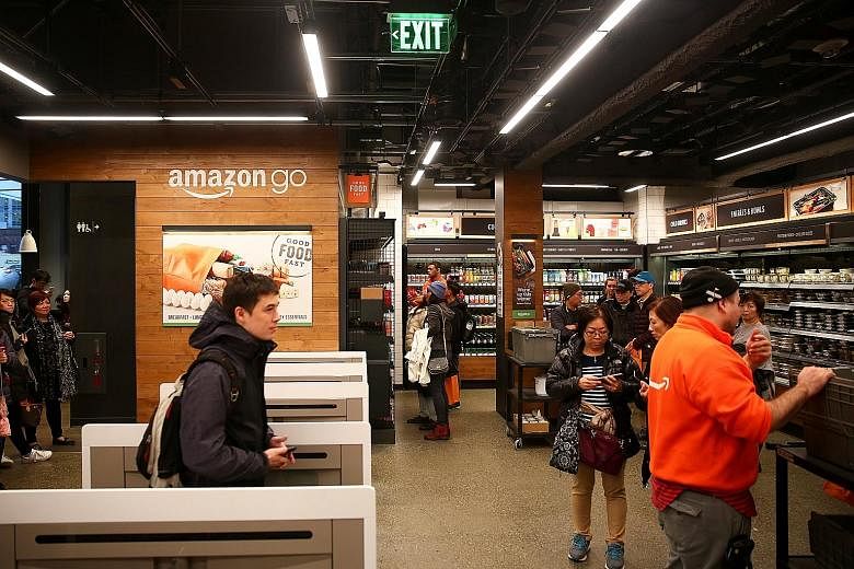 Customers browsing the Amazon Go store at Amazon's Seattle headquarters, where sensors and artificial intelligence have replaced cashiers.