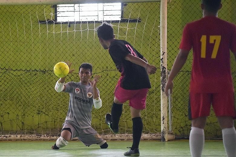 Eman Sulaeman in action during a futsal match in Indramayu, West Java, recently. The 30-year-old Indonesian, born with no feet and just one full leg, is wowing crowds at home and abroad with his "cat-like" reflexes, and knocking home a powerful messa