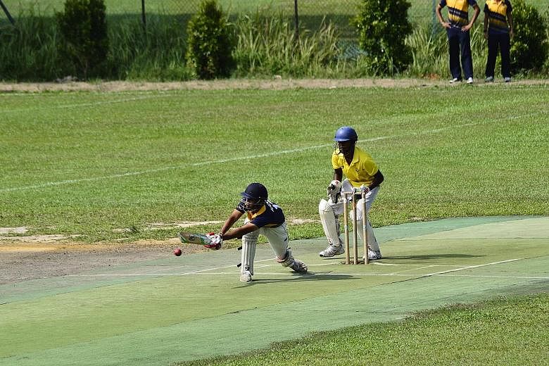 Victoria School wicket-keeper Joshua Pooranakaran follows the flight of the ball as Arnaav Chabria of Anglo-Chinese School (Independent) bats during the B Division cricket final at the Singapore Indian Association ground yesterday. The vice-captain h