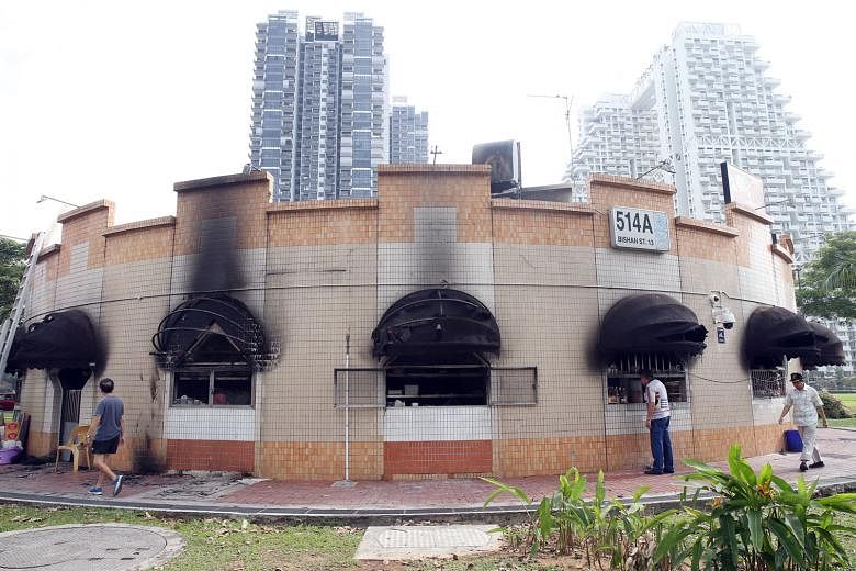 Two men were hurt when fire broke out at a coffee shop next to the Bishan bus interchange on Monday night. Yesterday morning, all the stalls in the coffee shop were closed. The building itself appeared intact although black soot covered parts of an e