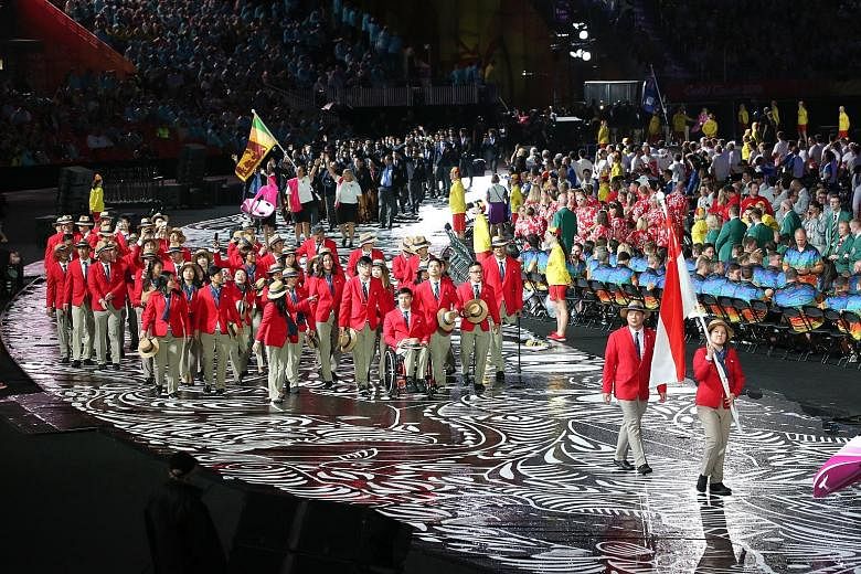 Flag-bearer and reigning Commonwealth Games 10m air pistol champion Teo Shun Xie leading the Singapore contingent during the opening ceremony in Carrara Stadium on Australia's Gold Coast yesterday. Singapore is represented in the Games by 60 athletes