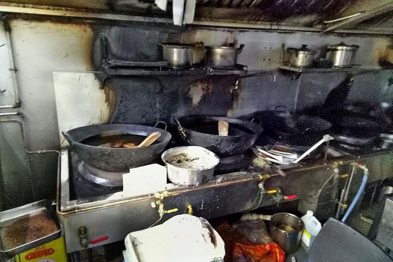 The charred remains of a kitchen at the coffee shop in Yishun where a fire broke out yesterday morning.