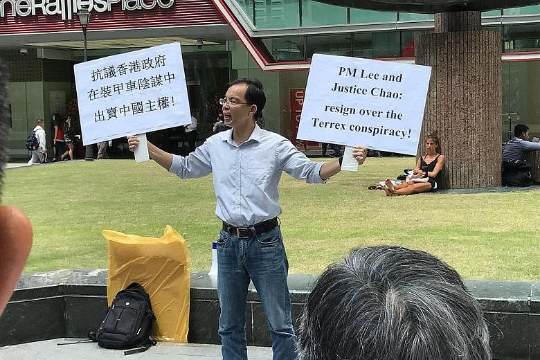 Yan Jun was seen holding placards while addressing the lunchtime crowd outside Raffles Place MRT station on Feb 22.
