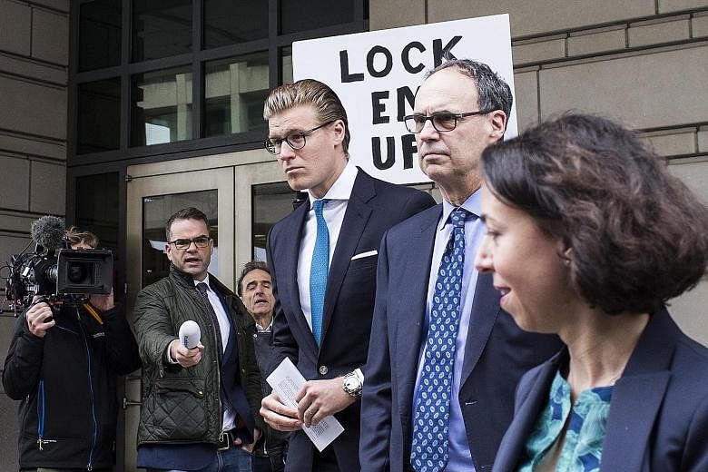 Alex van der Zwaan (third from right) exiting the Federal Court in Washington on Tuesday. He has been sentenced to 30 days in prison, two months of supervised release and fined.