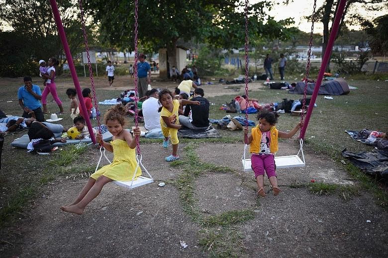 Children, among hundreds of Latin Americans in the migrant caravan that has infuriated US President Donald Trump, play as the group takes a breather in Matias Romero, southern Mexico, on Tuesday.