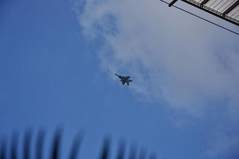 Above: A Republic of Singapore Air Force F-15SG fighter jet departing Changi Airport's airspace after escorting Flight TR634 back yesterday. Right: The Scoot plane returned to Changi Airport after the bomb threat was made, and was cleared for take-of