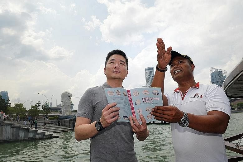 Bumboat captain Sazali Kassim showing NHB assistant chief executive of policy and community Alvin Tan sights of interest that he points out to passengers on his boat as he ferries them up and down the Singapore River. Mr Sazali has been using a new b