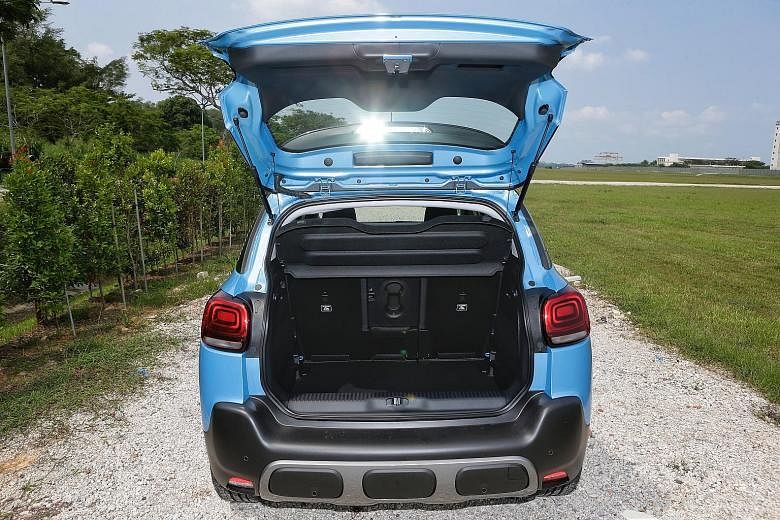 The Citroen C3 Aircross (left) has a large boot (far left) - the rear seats can slide forward, allowing for as much as 410 litres of stowage without folding any seats.