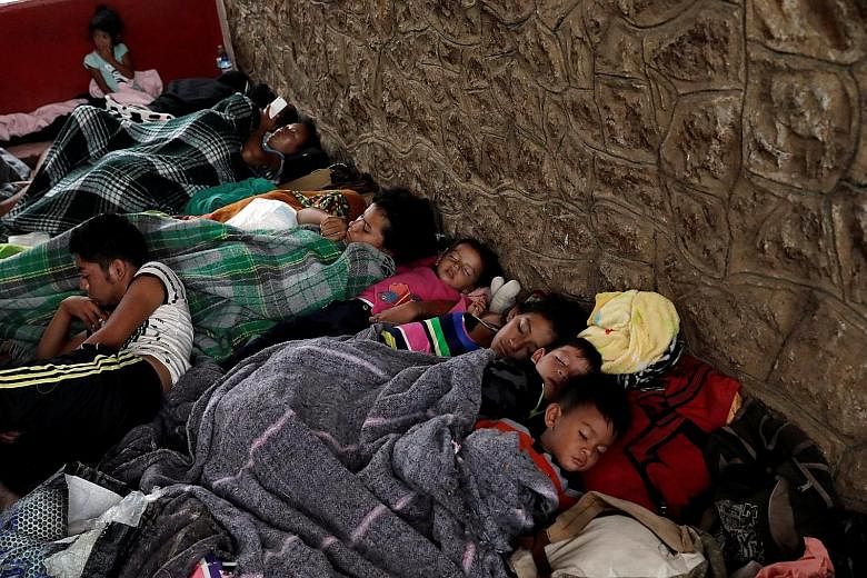 Children, part of a caravan of Latin American migrants moving through Mexico towards the US border, sleeping at a sports centre in Matias Romero on Thursday. The caravan aims to raise awareness about the plight of migrants, and has been running annua