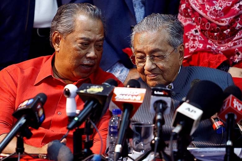 Tun Dr Mahathir Mohamad is attempting to unseat PM Najib Razak with the help of jailed opposition leader Anwar Ibrahim (in banner above). Former Malaysian prime minister Mahathir Mohamad with former deputy prime minister Muhyiddin Yassin at a news co
