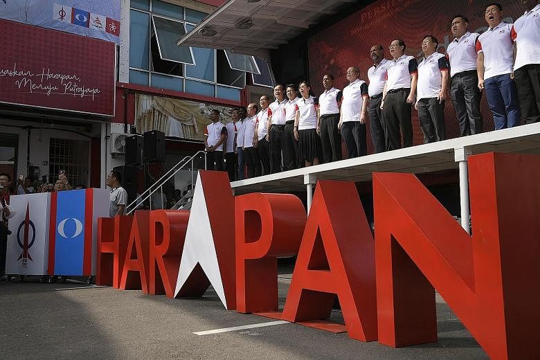 Members of the Democratic Action Party singing the national anthem during an opposition rally last month in Ayer Hitam, Johor.