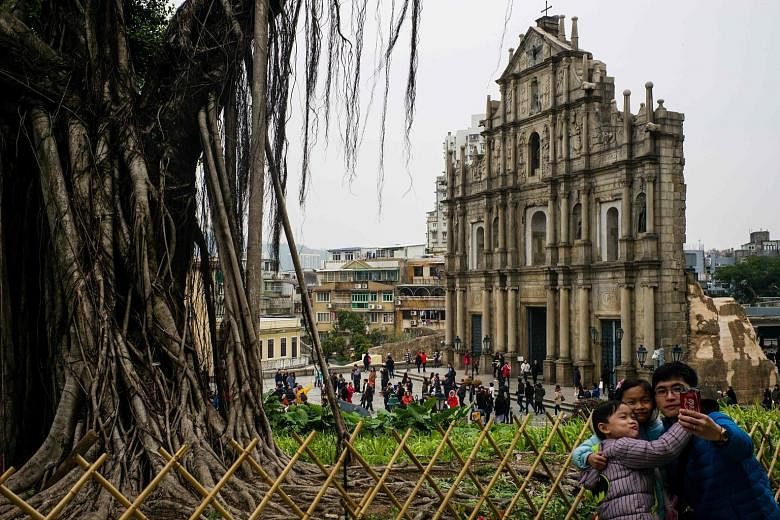 Tourists at the ruins of St Paul's Church, a 17th-century Portuguese complex, in Macau. Chinese citizens' thirst for travel is only just warming up with growing affluence and rising consumer confidence.