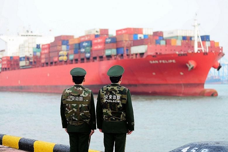 A cargo ship at a port in Qingdao, in China's eastern Shandong province. Prime Minister Lee Hsien Loong commented on the tit-for-tat tariff stand-off between China and the US, in an interview with the People's Daily newspaper published today.