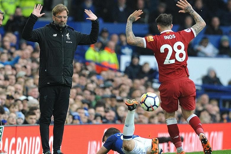 Liverpool manager Jurgen Klopp and Danny Ings reacting in unison after the forward's scuffle with Everton full-back Seamus Coleman. The teams played out a tepid goal-less draw.