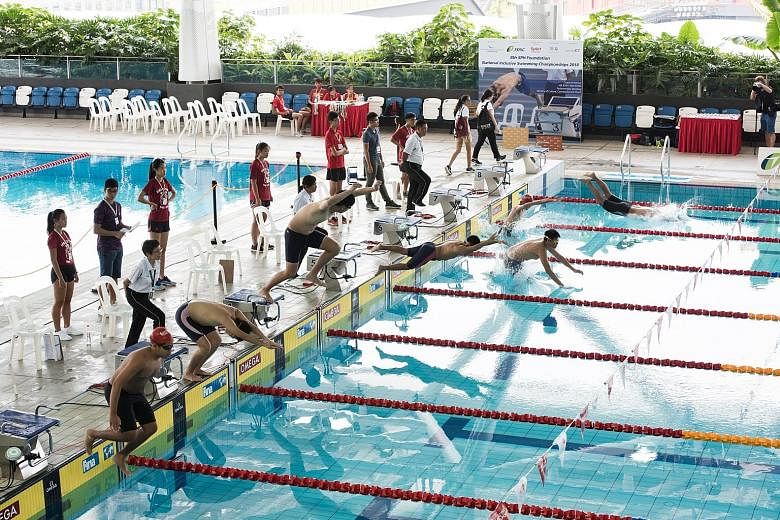 Competitors diving into the Tampines Swimming Complex pool at the National Inclusive Swimming Championships. This year's competition had swimmers with autism and Down syndrome taking part for the first time.
