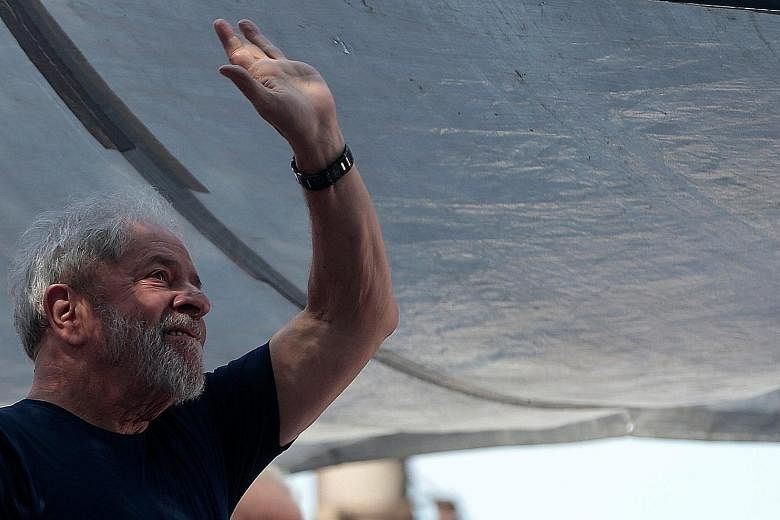Controversial leftist icon Luiz Inacio Lula da Silva waving to his supporters after emerging yesterday following two days holed-up.
