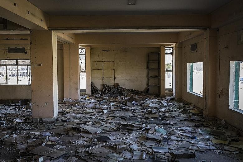 (Left) One of the land leases which the Islamic State in Iraq and Syria had stolen from members of religious groups it chased out. (Far left) Paperwork littering Mosul's bombed-out Ministry of Agriculture last September.