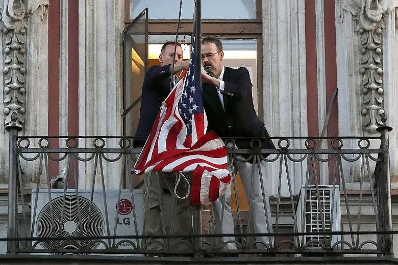 Employees of the US Consulate in St Petersburg removing the US flag last month, after Moscow ordered the closure of the consulate in an ongoing tit for tat over the poisoning of former Russian spy Sergei Skripal in Britain.