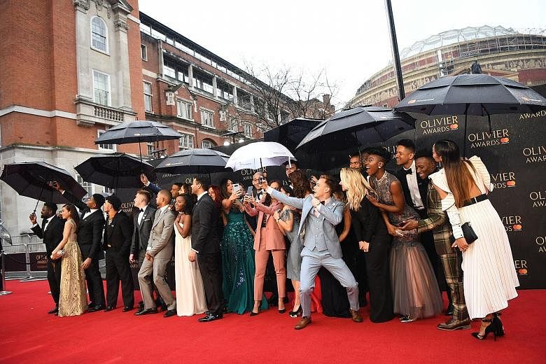 The stars of the West End version of the American musical Hamilton arrived with umbrellas at the ceremony at London's Royal Albert Hall on Sunday.