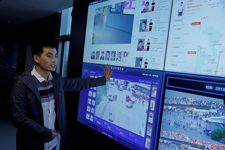 Co-founder Xu Chiheng with SenseTime's technology. The firm specialises in systems that analyse faces and images on a large scale.