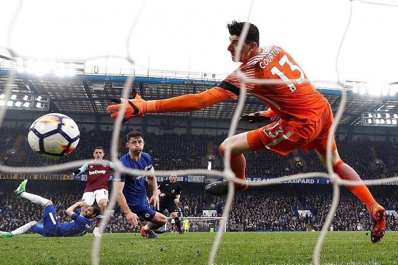 Chelsea's Thibaut Courtois is unable to keep out a precise effort by West Ham substitute Javier Hernandez. The two sides played out a 1-1 draw.