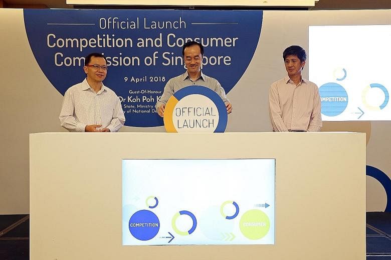 (From left) Competition and Consumer Commission of Singapore chairman Aubeck Kam, Senior Minister of State for Trade and Industry and National Development Koh Poh Koon, and CCCS chief executive Toh Han Li at the launch of the competition watchdog's n