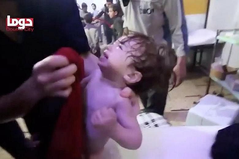 A child getting help following an alleged chemical weapons attack in what is said to be the Syrian town of Douma. Mr Donald Trump had warned of a "big price to pay" following the reports of the poison gas attack.