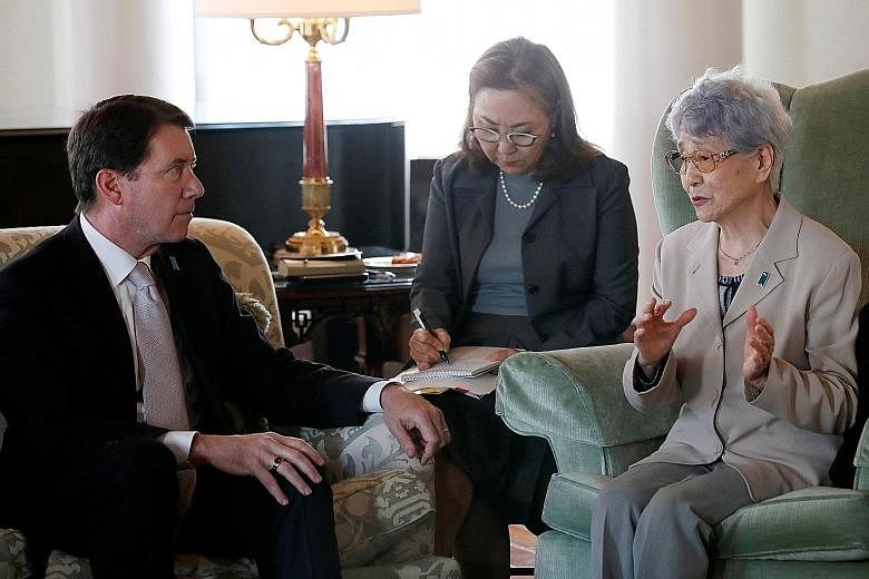 Madam Sakie Yokota, whose daughter Megumi was abducted by North Korean agents at age 13 in 1977, meeting US Ambassador to Japan William Hagerty yesterday. Mr Hagerty pledged to convey the plight of affected families to US President Donald Trump ahead
