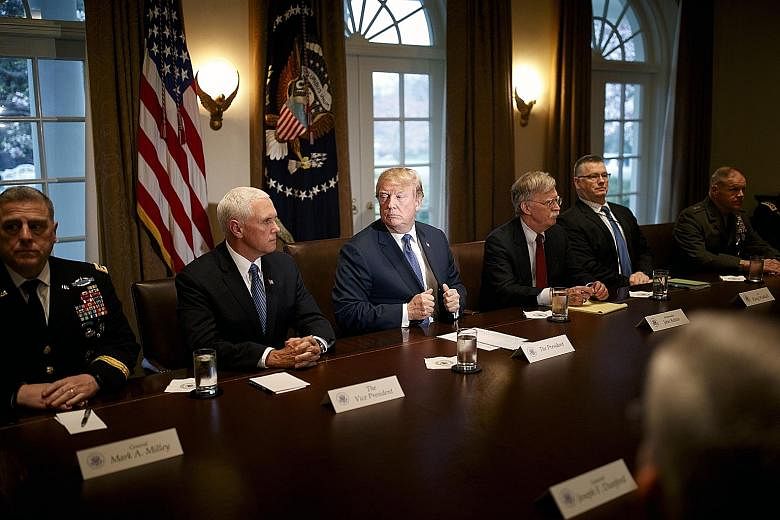 United States President Donald Trump flanked by Vice-President Mike Pence on his right and National Security Adviser John Bolton, as he met senior military leaders at the White House on Monday. Mr Trump said he would take a decision that night or sho