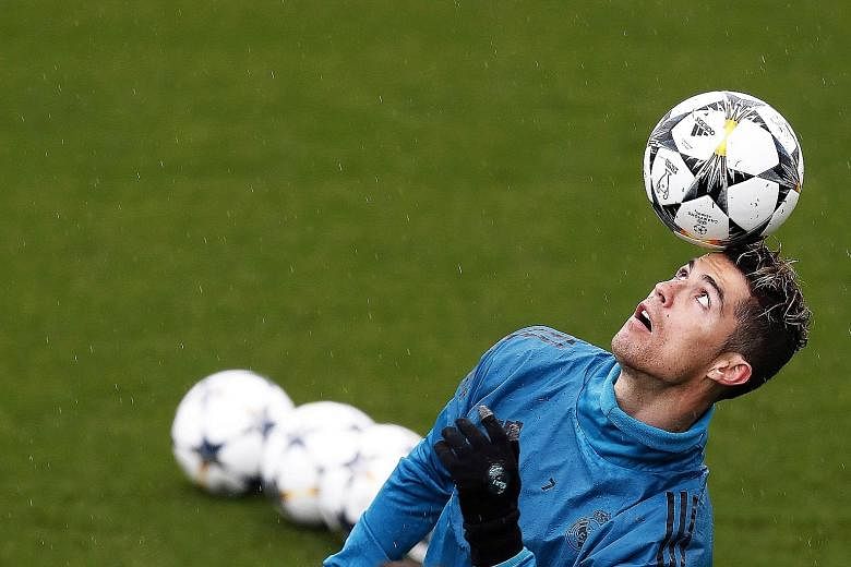 Cristiano Ronaldo has eyes only for the ball during a training session ahead of Real Madrid's return leg against Juventus. Real, ahead by three away goals, are odds-on favourites to progress to the semi-finals with the Portuguese forward eyeing anoth