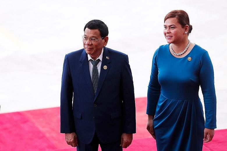 Philippine President Rodrigo Duterte and his partner Honeylet Avancena arriving for the opening of the Boao Forum for Asia on China's Hainan Island yesterday. Mr Duterte said his country and China "stand together in the war on criminality and the ill
