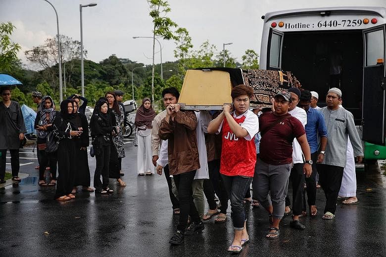 Left: Relatives carrying the casket of former police officer Mirkhan Ariffin Ahmad (above) at the Muslim Cemetery last Friday. The father of three died last Thursday after he was injured in a motorbike accident while on holiday with his wife in Bali 