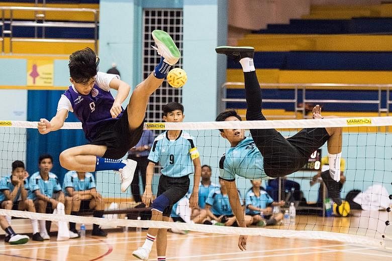 Queensway Secondary School (in purple) were crowned Schools B Division sepak takraw champions yesterday after beating Assumption Pathway School 2-1 at the Yio Chu Kang Sports Hall. It was their third straight B Division boys' title. Queensway also ce