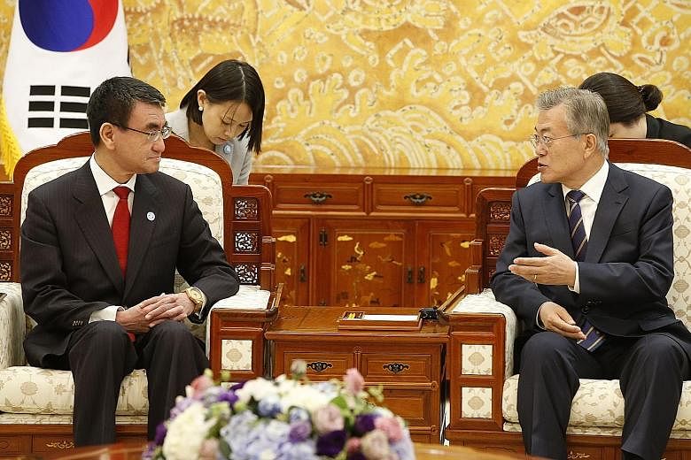 South Korean President Moon Jae In (right) in talks with Japanese Foreign Minister Taro Kono at the presidential house in Seoul yesterday.