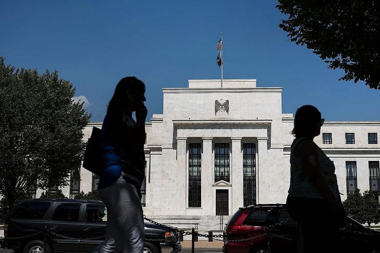 Even with the improved outlook, a "strong majority" of Fed officials voiced concern that a trade war would harm the economy, and some policymakers said the recent turbulence in markets highlighted risks to growth.