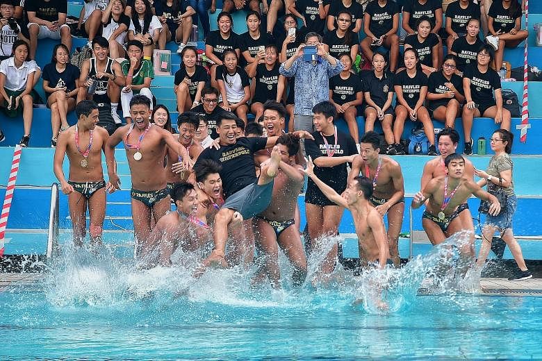 Raffles Institution (RI) water polo players celebrate winning the Schools National A Division boys' title by throwing coach Yu Lei into the pool. The defending champions beat Anglo-Chinese School (Independent) 5-4 at the MOE (Evans) Swimming Complex 