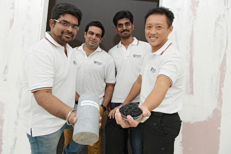 (From left) Research assistant Manikandan Jayaraj, PhD student Souradeep Gupta, research assistant Chakradha Pedapati and Dr Kua Harn Wei with biochar, a material produced when heat is used to decompose sawdust, and a concrete column containing bioch