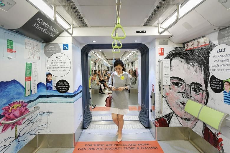 A woman walking by works of art by Ng Li Jie, 21, (on the left), and Sean Bay, 22, on a Downtown Line train. Choo Jian Wei (below left), 17, with his sketch on the same train.
