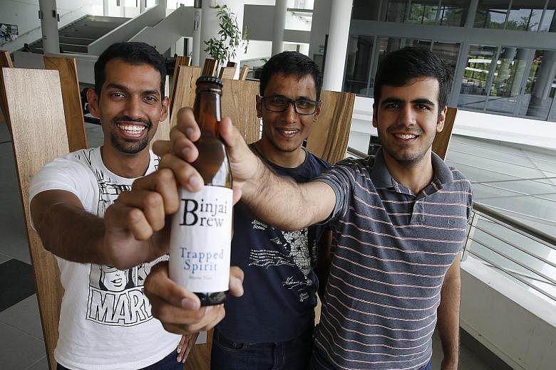 (From left) NTU engineering students Rahul Immandira, Abilash Subbaraman and Heetesh Alwani, makers of the "Binjai Brew", built from scratch a "cold box" - a fridge that controls the temperature of the beer as it ferments. In total, they spent about 
