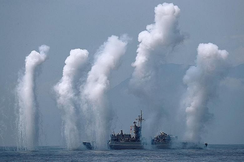 Flares being set off from Taiwanese frigate Fong Yang during a drill yesterday near Yilan naval base, in the east. Amid rising tensions with Beijing, Taiwanese President Tsai Ing-wen presided over the military drill by the island's navy for the first