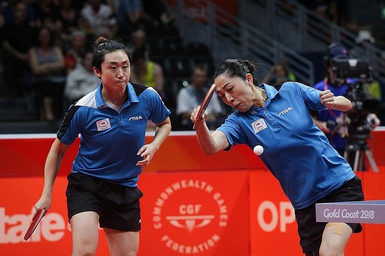 Singapore's Feng Tianwei (far left) and Yu Mengyu on their way to winning gold in the Commonwealth Games women's doubles final yesterday. They beat India's Manika Batra and Mouma Das 11-5, 11-4, 11-5 to retain the title they won in Glasgow in 2014.