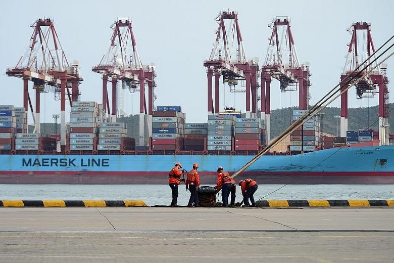Workers at a port in Qingdao, in China's Shandong province. China's trade surplus with the US in the first quarter rose 19.4 per cent year on year to $76 billion.