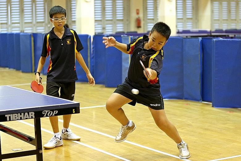 Ryan Chong returning a tough shot as Seth Wong looked on during the team's win over Kuo Chuan in the South Zone C Division third-place play-off in February.