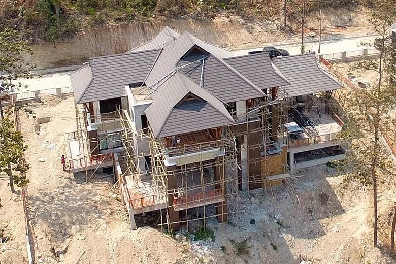 Construction activity on the housing project has stopped, although it is due to be completed in June. A panel will decide which buildings encroach on forest land and should be demolished.