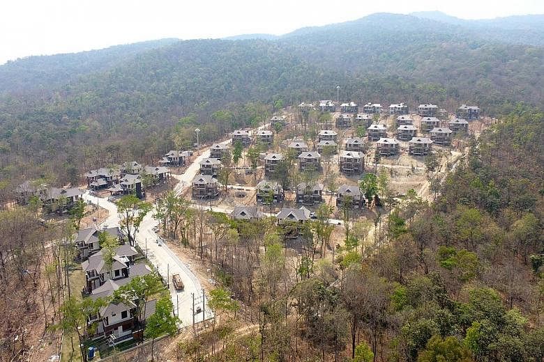 Construction activity on the housing project has stopped, although it is due to be completed in June. A panel will decide which buildings encroach on forest land and should be demolished.