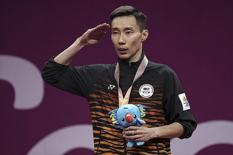 Gold medallist Lee Chong Wei saluting during the Malaysian anthem at yesterday's medal ceremony. Having never won the Olympic gold, he says he may still give it a shot at the 2020 Tokyo Games, when he will be almost 38.