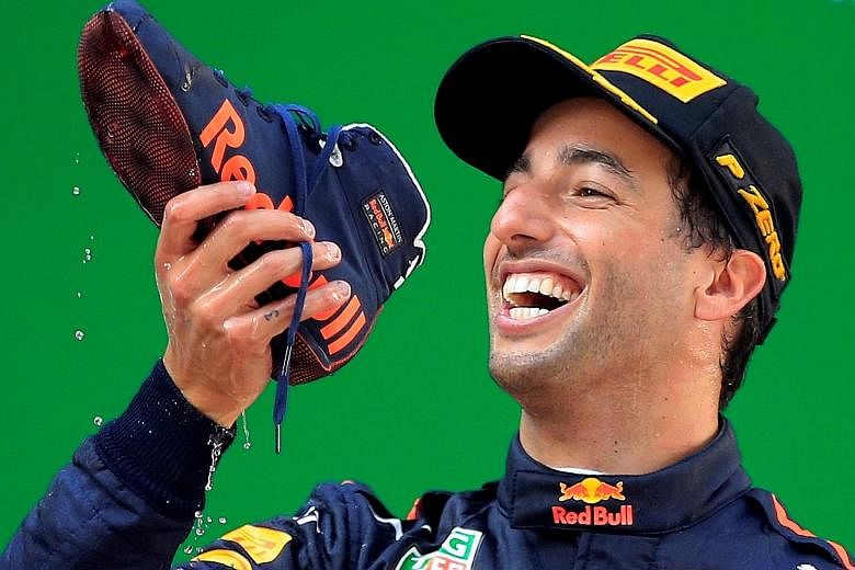Red Bull's Australian driver Daniel Ricciardo doing a 'shoey' - drinking champagne from a shoe - as he celebrates his victory in the Chinese Grand Prix in Shanghai yesterday.