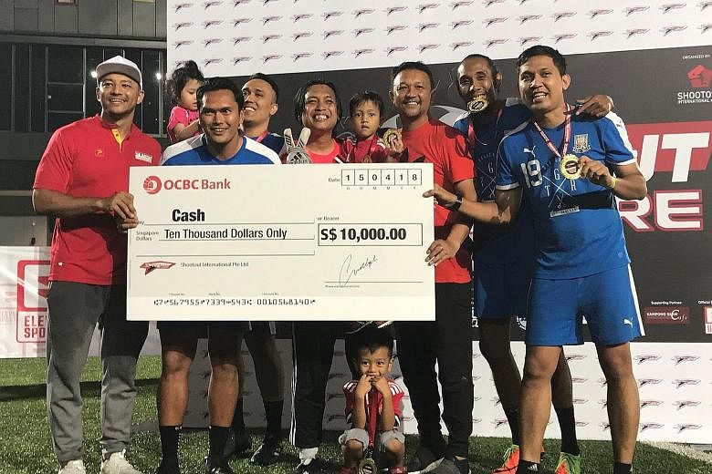 The Shootout organiser, Imran Abdul Rahman (left) and Fandi Ahmad handing the $10,000 winners' cheque to former Singapore international Tengku Mushadad (third from left) and his team, named 8ighty 4our. The 33-year-old and 8ighty 4our were the last t
