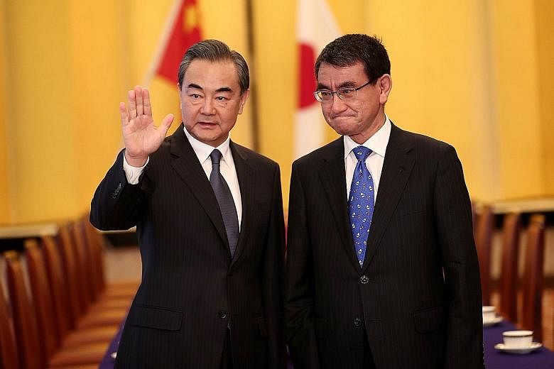 Japan's Mr Taro Kono (right) and China's Mr Wang Yi reiterated yesterday that bilateral ties were at a crucial turning point.