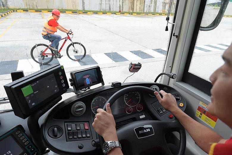 A bus fitted with the I-SAW-U system that has smart camera sensors which can analyse and detect objects in front and at the sides of the vehicle. A screen mounted on the bus dashboard sounds an audible warning and flashes to show the driver where the